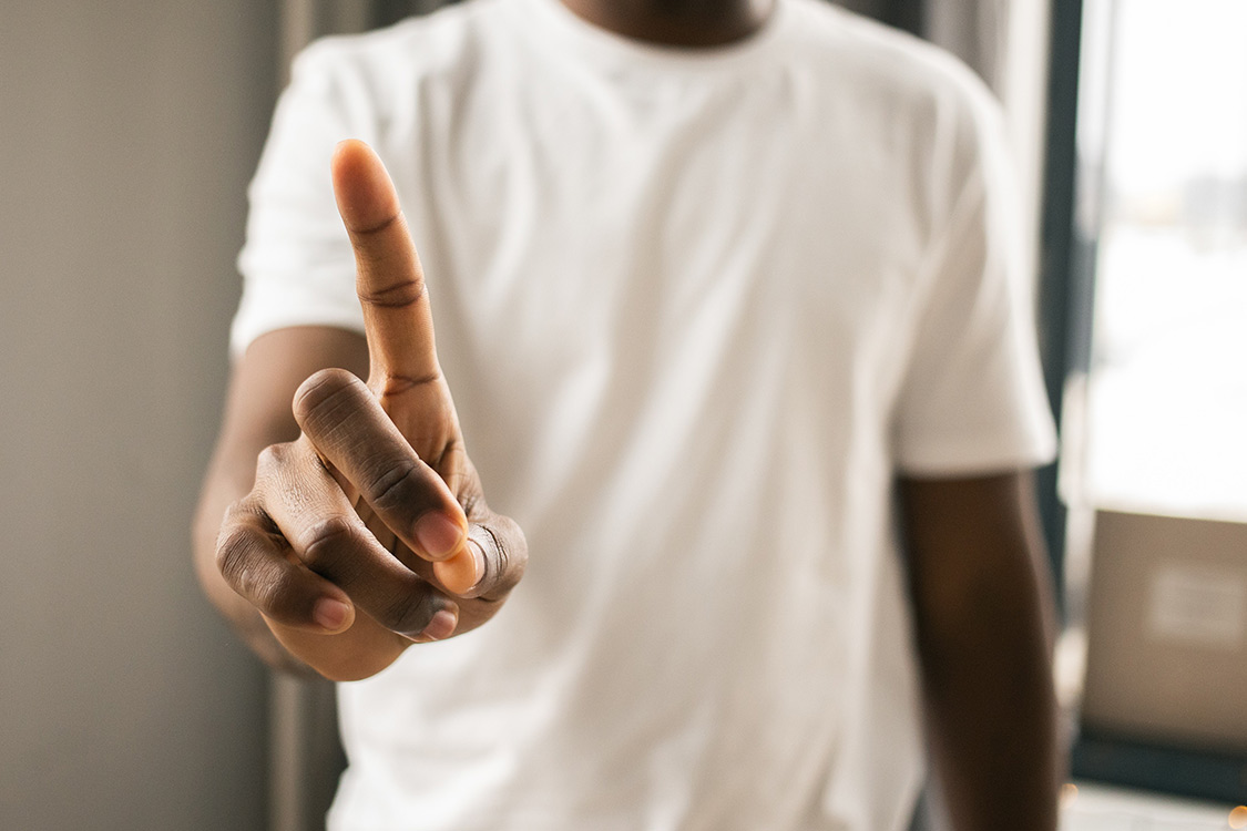 Mann in weißem tshirt der sein zeigefinger hinhält